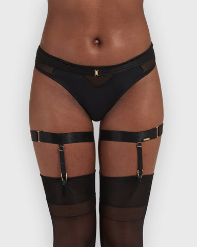 Adjustable black garter leg suspenders with gold metal details, featuring thigh suspenders with four suspender clips.